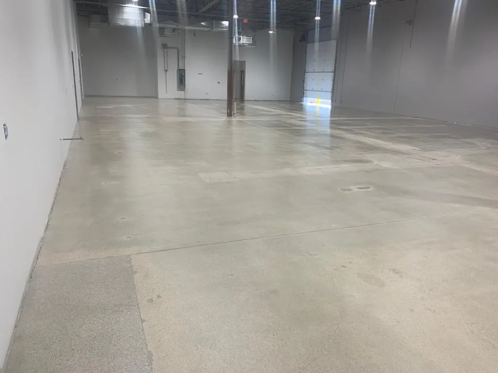 Professional inspecting polished concrete floor, emphasizing the importance of expert restoration services
