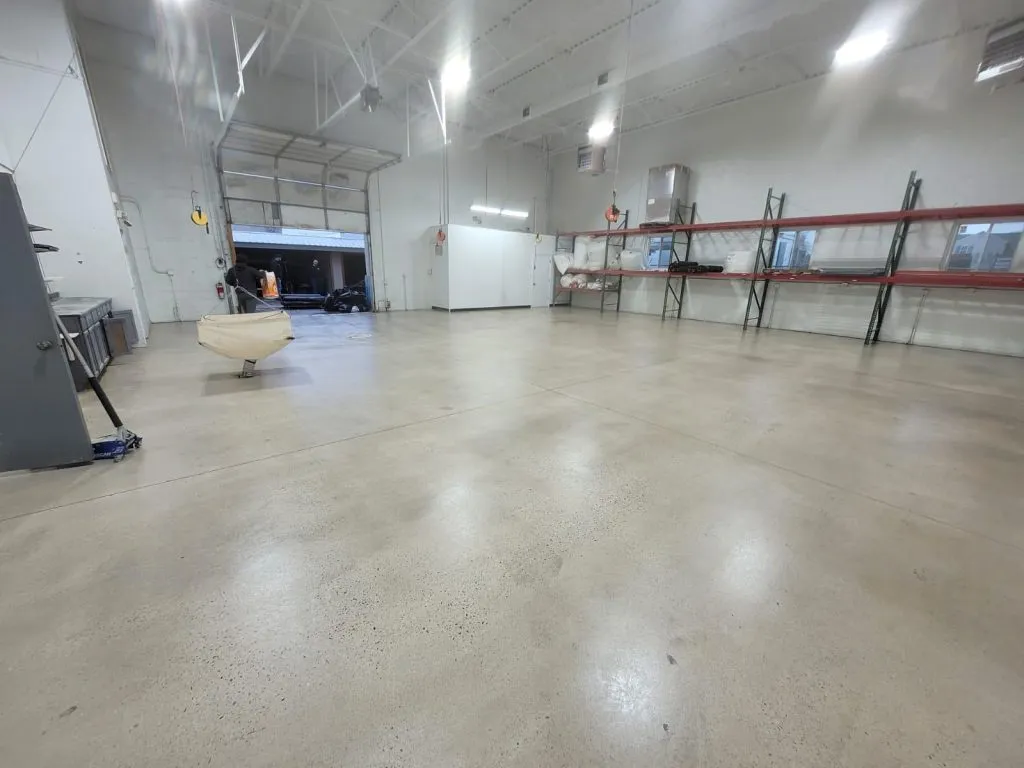 Person cleaning polished concrete floor with a microfiber mop, illustrating regular maintenance practices