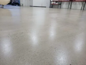 Smooth, reflective grey polished concrete floor in a commercial space.